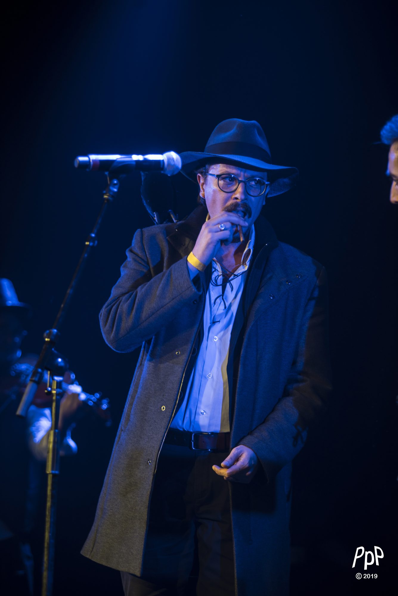 Marc Wencelius singing at the microphone, 2019
